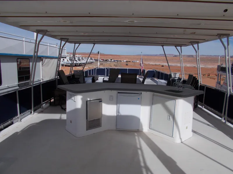 Slide: The Image of 2006 American Waterways Sapphire Skies 1/10 Ownership houseboat with outdoor bar and seating area. - 25