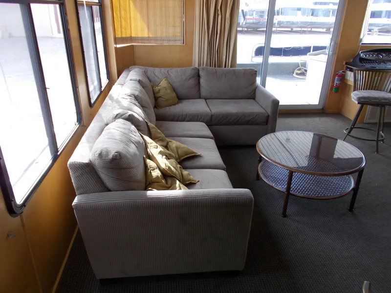 Slide: The Image of Living area of 2006 American Waterways Sapphire Skies houseboat with sectional sofa and glass coffee table. - 3
