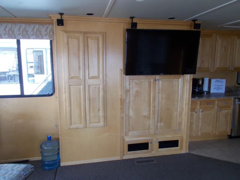 Slide: The Image of Interior of 2006 American Waterways Sapphire Skies houseboat with TV and wooden cabinetry. - 5