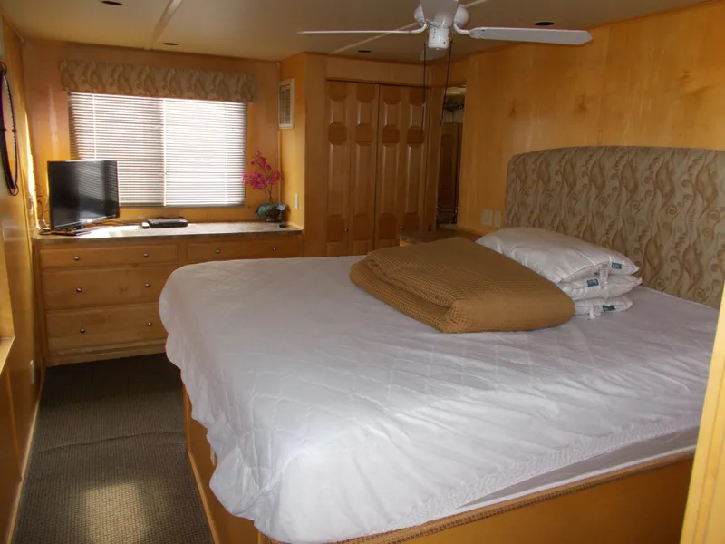 Slide: The Image of Cozy bedroom in 2006 American Waterways Sapphire Skies houseboat with TV and ample storage. - 9