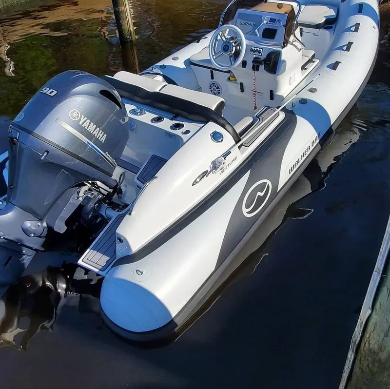 Slide: The Image of 2025 Walker Bay Venture boat with Yamaha 90 engine docked in water. - 1