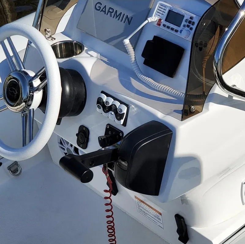 Slide: The Image of 2025 Walker Bay Venture boat console with Garmin navigation system and steering wheel. - 10