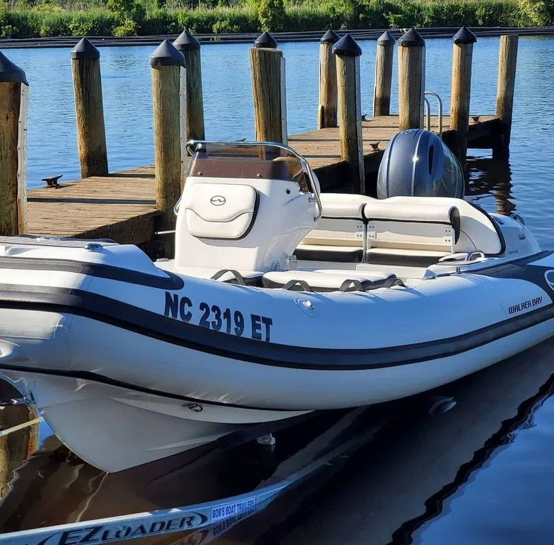 Slide: The Image of 2025 Walker Bay Venture boat docked by wooden pier. - 3