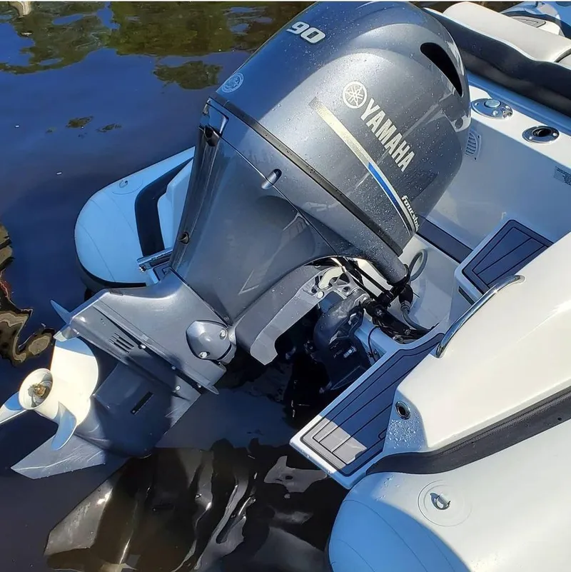 Slide: The Image of Walker Bay Venture 2025 boat with Yamaha 90 outboard motor in water. - 4
