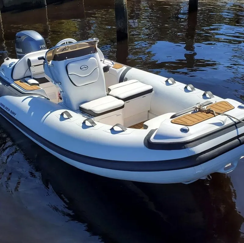 The Image of 2025 Walker Bay Venture inflatable boat with Yamaha 70 outboard motor on water. - 0