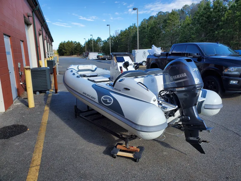 Slide: The Image of 2025 Walker Bay Venture boat with Yamaha 70 engine parked outside a building. - 10