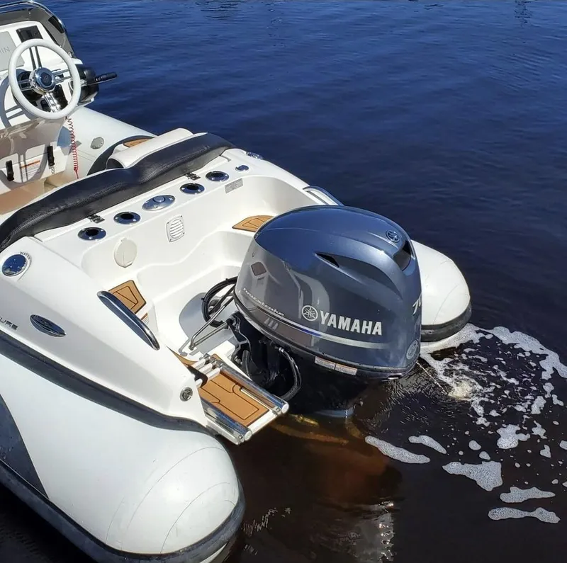 Slide: The Image of Walker Bay Venture 2025 boat with Yamaha outboard motor on calm water. - 4