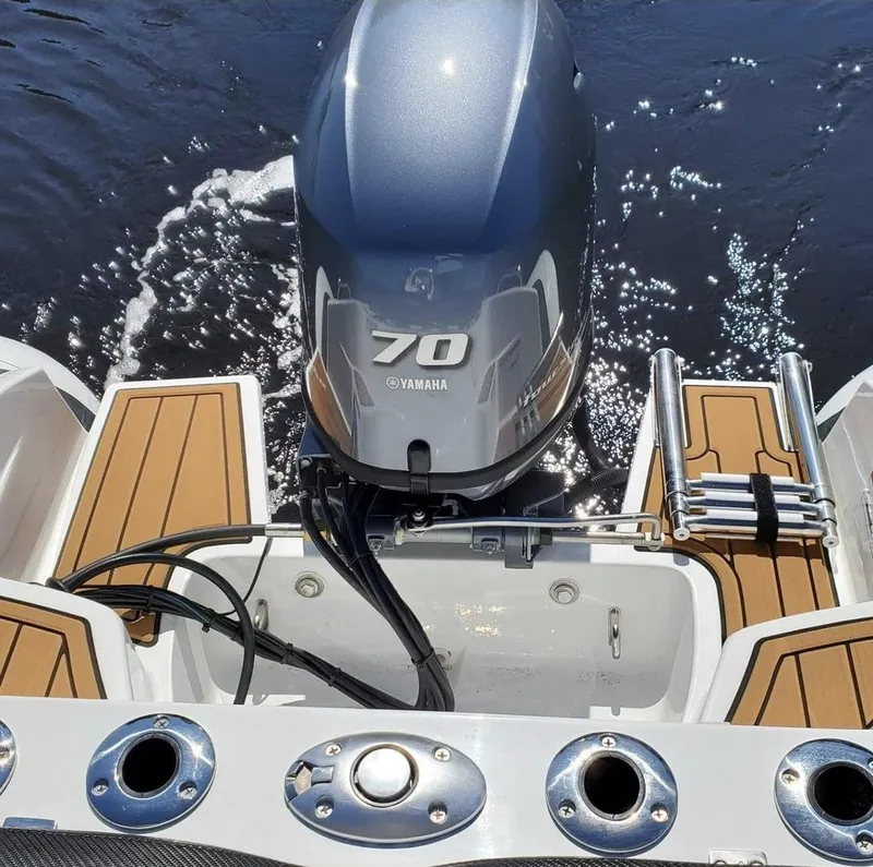Slide: The Image of 2025 Walker Bay Venture boat with Yamaha 70 outboard motor on water. - 5