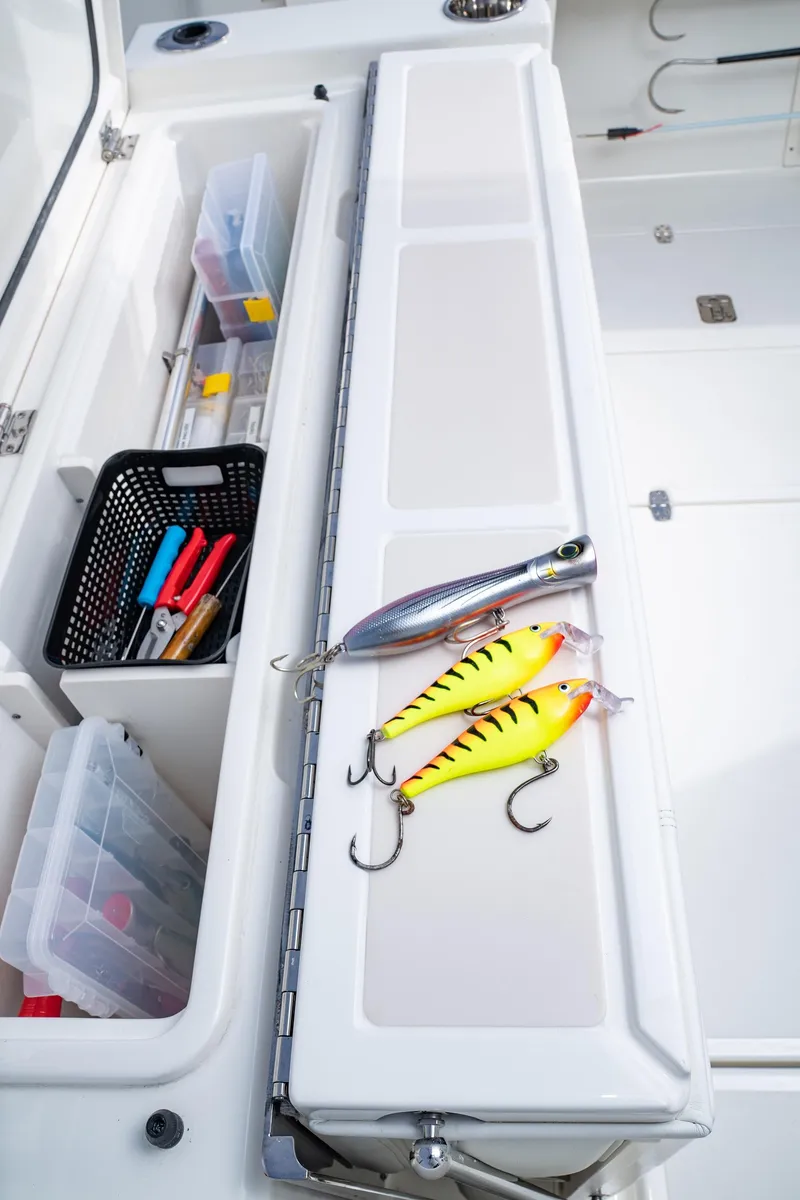 Slide: The Image of 2025 Pursuit S 378 boat with fishing tackle and lures in storage compartment. - 10