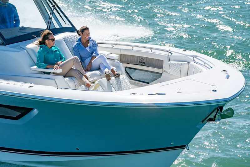 Slide: The Image of 2025 Pursuit S 378 boat cruising with passengers relaxing on deck. - 4