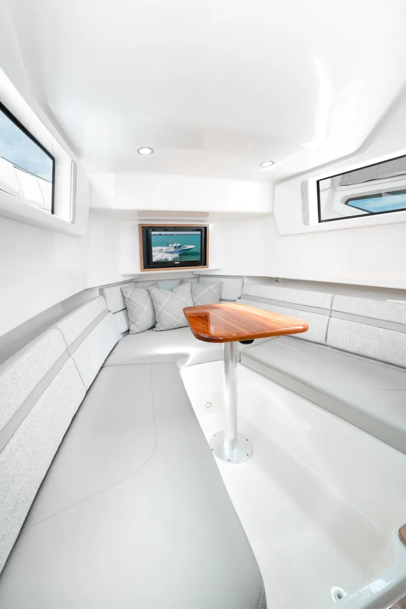 Slide: The Image of Interior cabin of 2025 Pursuit S 378 boat with modern seating and wooden table. - 5