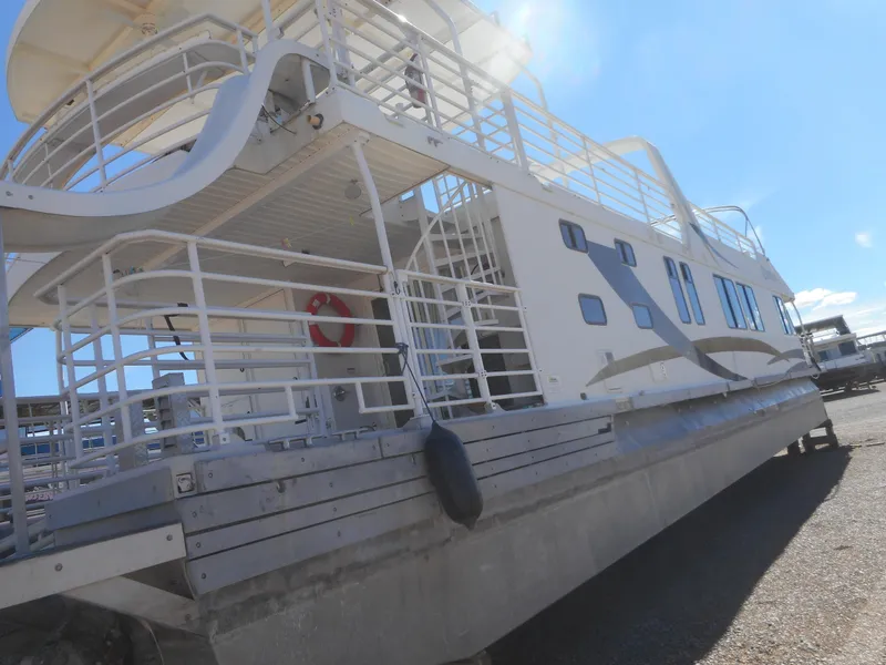 Slide: The Image of 2005 Twin Anchors Caspian #3 houseboat with white exterior and spacious deck. - 10