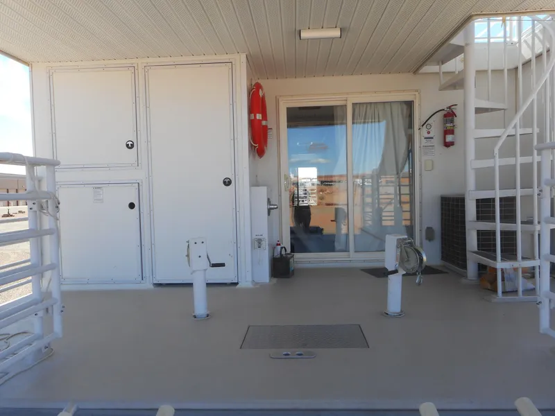 Slide: The Image of Houseboat deck with sliding glass door, spiral staircase, and safety equipment, Twin Anchors Caspian #3, 2005. - 13