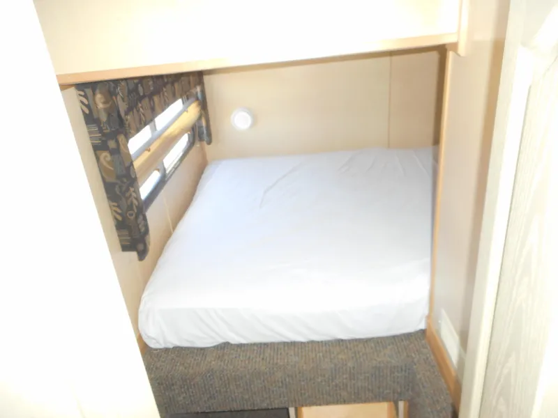 Slide: The Image of Compact bedroom in 2005 Twin Anchors Caspian #3 houseboat with cozy bed and window. - 20