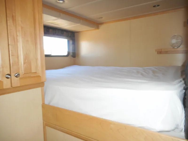Slide: The Image of Interior of 2005 Twin Anchors Caspian #3 with cozy bed and wooden cabinetry. - 22