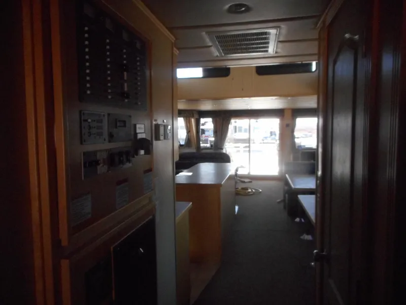 Slide: The Image of Interior of 2005 Twin Anchors Caspian #3 houseboat, featuring control panel and seating area. - 23