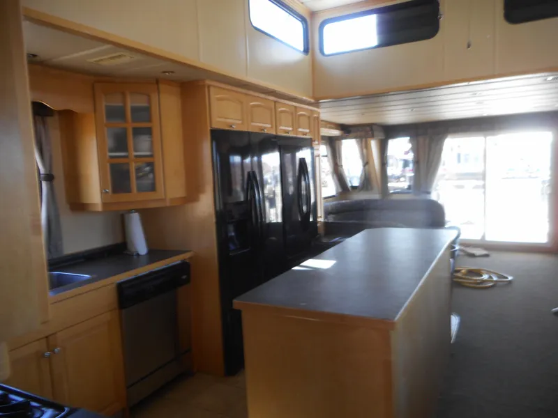Slide: The Image of Spacious 2005 Twin Anchors Caspian #3 houseboat kitchen with modern appliances and ample natural light. - 24