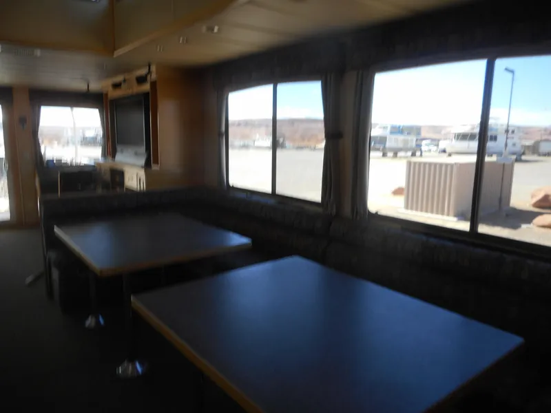 Slide: The Image of Interior of 2005 Twin Anchors Caspian #3 houseboat with large windows and dining area. - 25