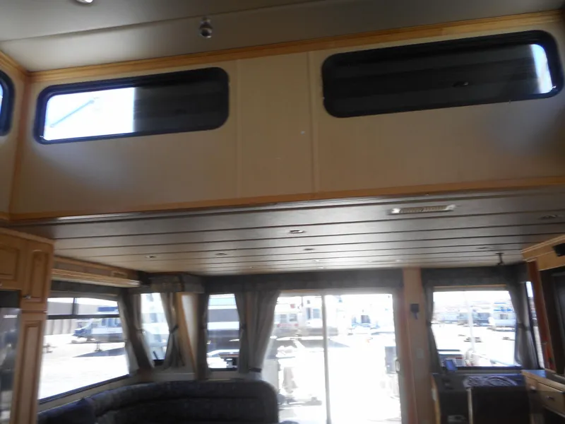 Slide: The Image of Interior of 2005 Twin Anchors Caspian #3 houseboat with large windows and cozy seating area. - 26