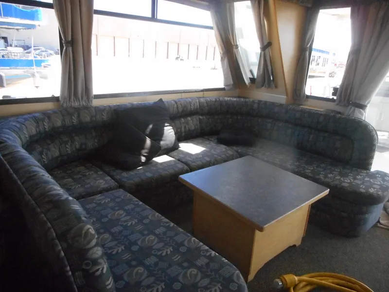 Slide: The Image of Spacious interior of 2005 Twin Anchors Caspian #3 houseboat with cozy seating and table. - 27