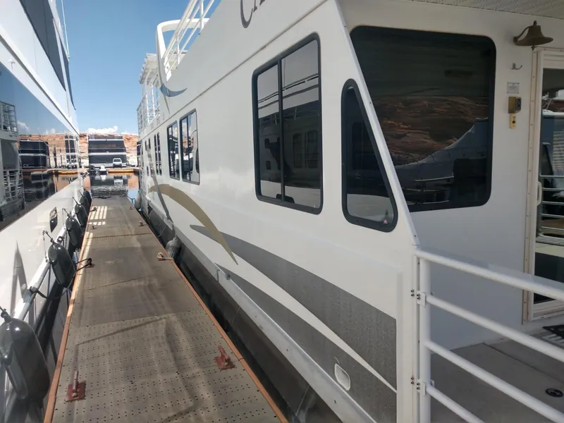 Slide: The Image of Twin Anchors Caspian #3 houseboat docked, side view, 2005 model. - 3