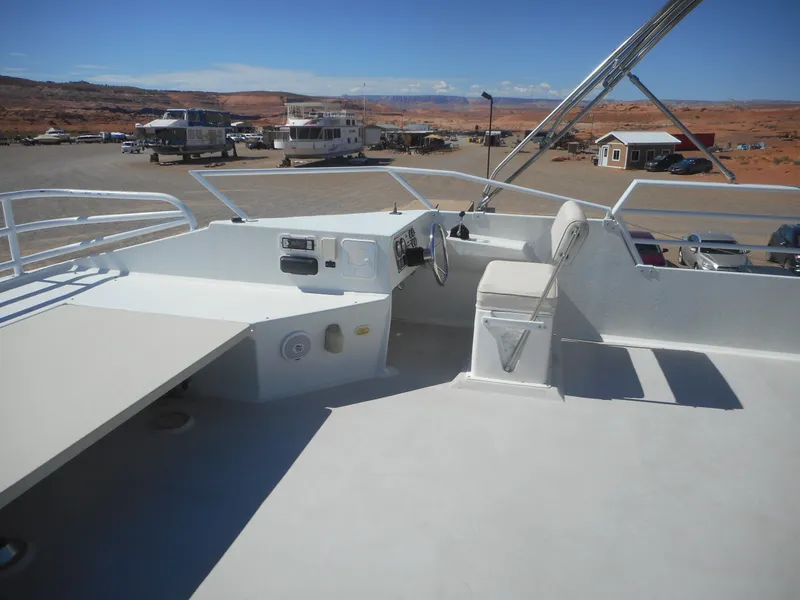 Slide: The Image of Twin Anchors Caspian #3 houseboat deck, 2005 model, with steering controls and seating. - 31