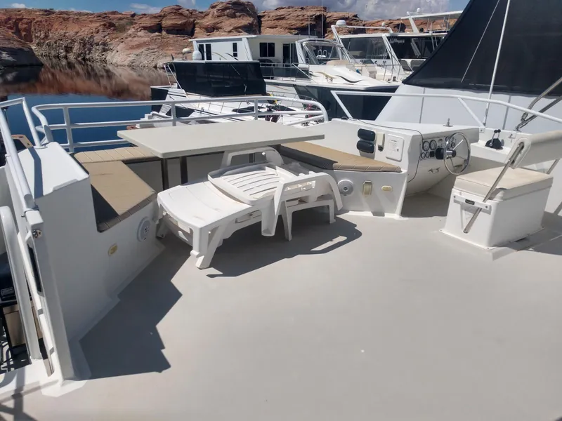 Slide: The Image of Upper deck of 2005 Twin Anchors Caspian #3 houseboat with lounge chairs and control panel. - 5