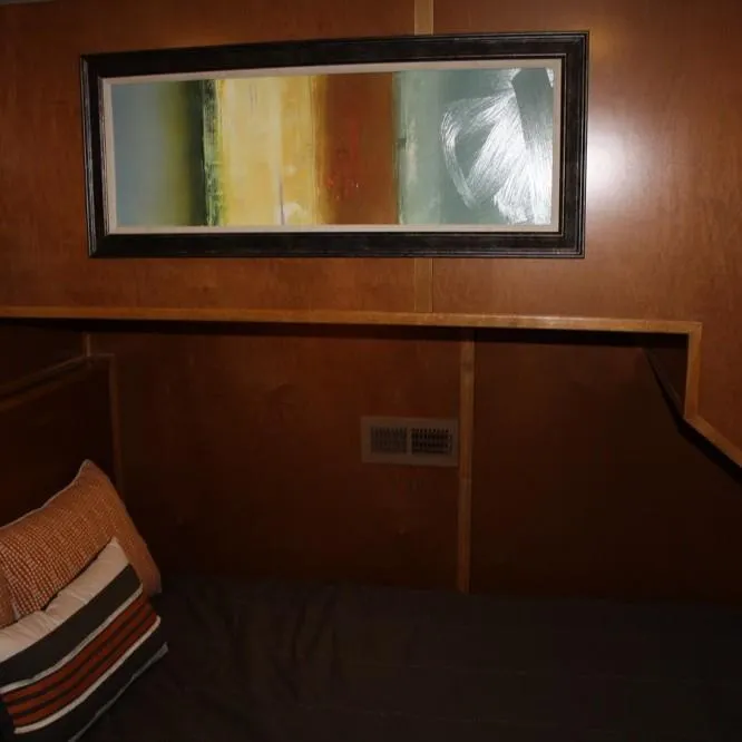 Slide: The Image of Interior of 2015 Bravada Intrepid Share #1 with abstract wall art and wooden paneling. - 20