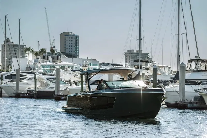 Slide: The Image of 2023 Aviara AV40 luxury boat docked at a marina with cityscape background. - 0