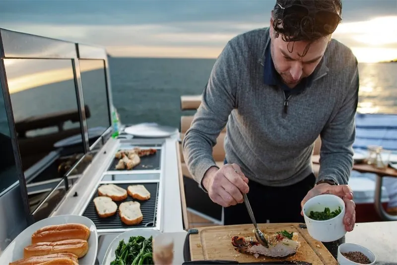 Slide: The Image of Man cooking on Aviara AV40 boat, 2023 model, with ocean view. - 10
