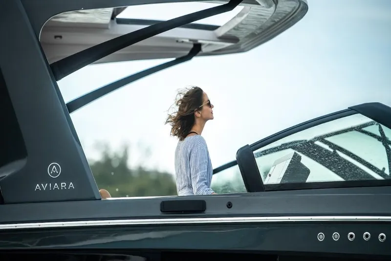 Slide: The Image of 2023 Aviara AV40 luxury boat with a woman enjoying the view. - 12