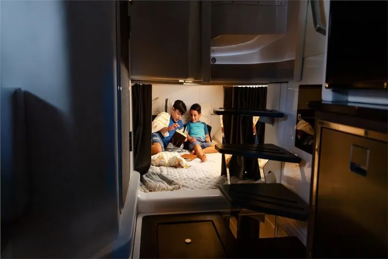 Slide: The Image of Children reading in cozy cabin of 2023 Aviara AV40 boat. - 15