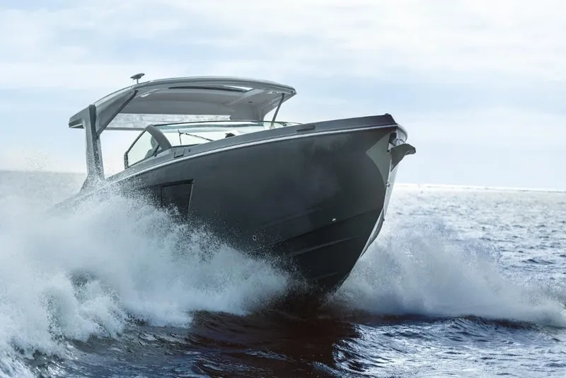 Slide: The Image of 2023 Aviara AV40 luxury boat cruising on open water. - 2