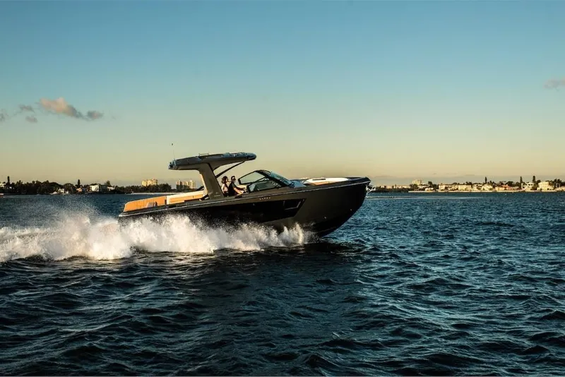 Slide: The Image of 2023 Aviara AV40 luxury boat cruising on open water at sunset. - 5