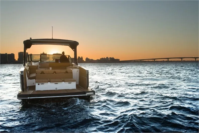 Slide: The Image of 2023 Aviara AV40 boat cruising at sunset on open water. - 7