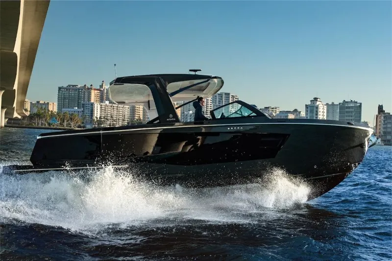 Slide: The Image of 2023 Aviara AV40 luxury boat cruising near city skyline. - 8