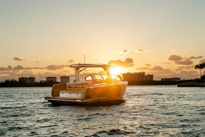 Slide: The Image of 2023 Aviara AV40 boat cruising at sunset on a serene waterway. - 9