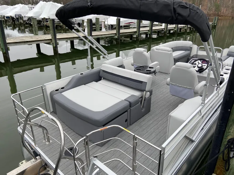 Slide: The Image of 2020 Sweetwater 2286 SFL pontoon boat with spacious seating and sleek design at a dock. - 10