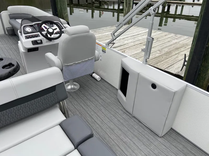 Slide: The Image of 2020 Sweetwater 2286 SFL boat interior with gray seating and steering console. - 11