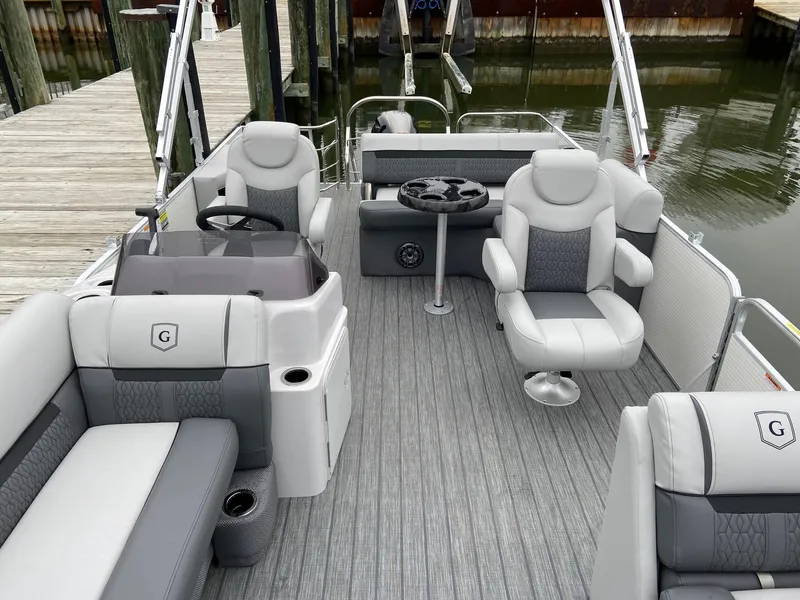 Slide: The Image of 2020 Sweetwater 2286 SFL pontoon boat interior with gray seating and steering console. - 14