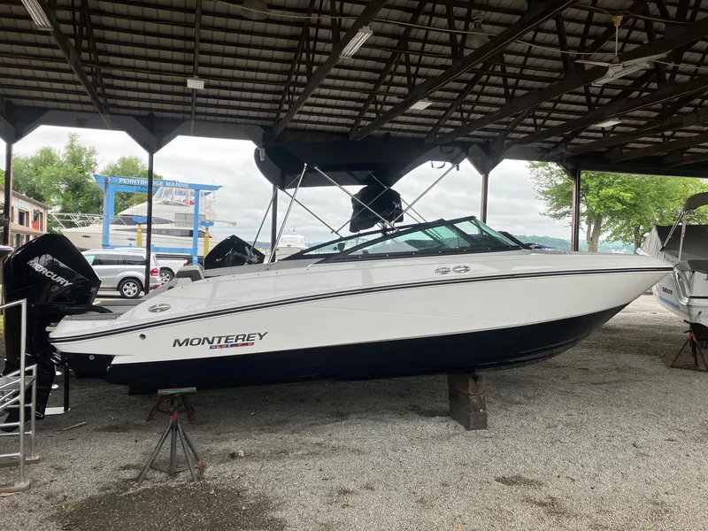 The Image of 2023 Monterey M-225 boat displayed in a covered marina. - 0