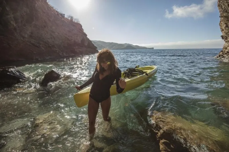 Slide: The Image of Woman with Hobie Mirage Compass kayak in scenic coastal waters, 2023 model. - 3