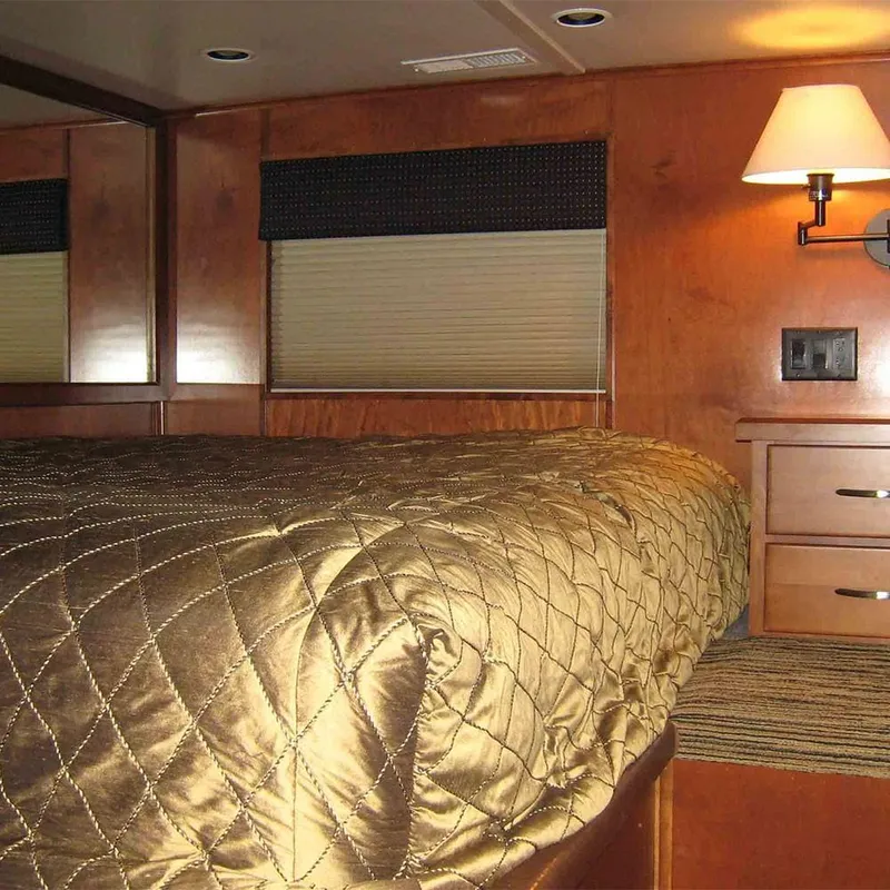 Slide: The Image of Interior of 2010 Bravada Dream Catcher Trip 14 RV bedroom with quilted bedspread. - 3