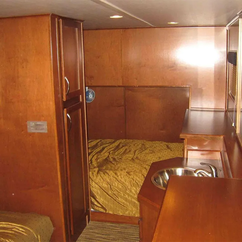 Slide: The Image of Interior of 2010 Bravada Dream Catcher Trip 14 houseboat with wooden cabinetry and bed. - 5