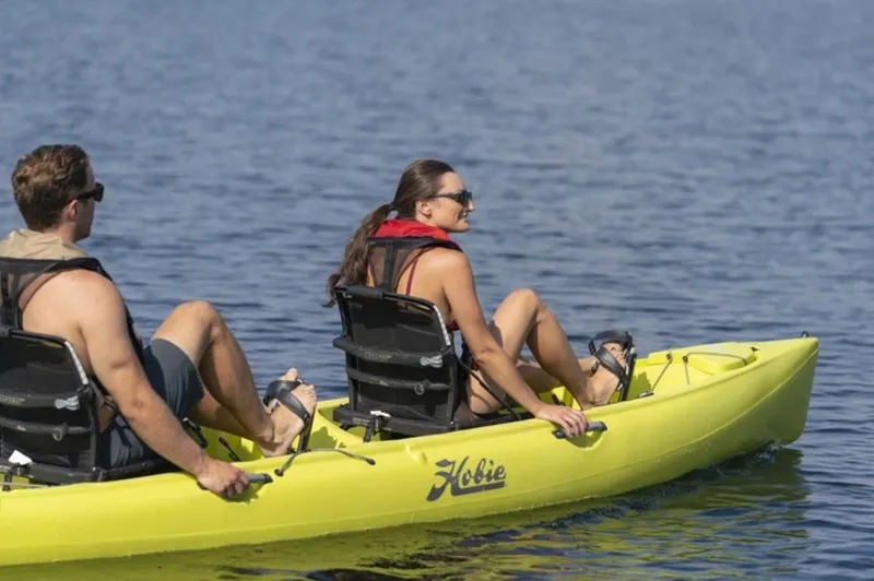 Slide: The Image of Two people kayaking on a 2023 Hobie Mirage Oasis in calm waters. - 5