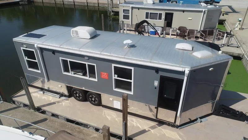 Slide: The Image of Harbor Home 24' 2020 model houseboat docked at marina. - 0