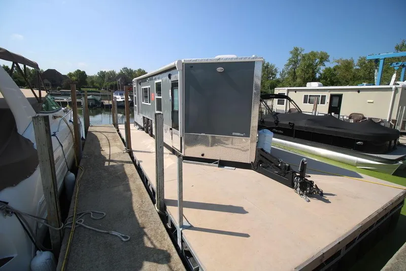 Slide: The Image of Harbor Home 24' 2020 model houseboat docked at a marina on a sunny day. - 10
