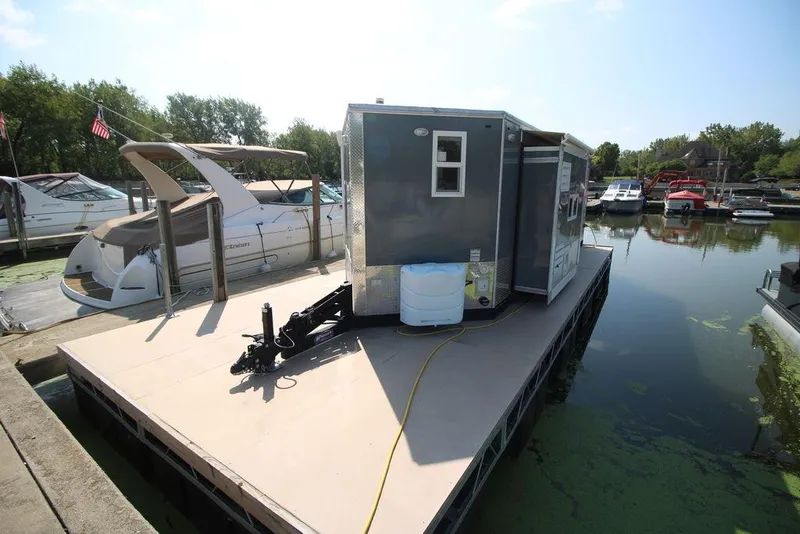 Slide: The Image of 2020 Harbor Home 24' houseboat docked at a marina. - 11