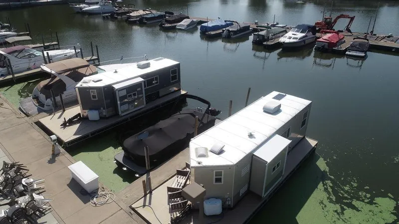 Slide: The Image of Houseboats docked at a marina, Harbor Home 24' model, 2020. - 12
