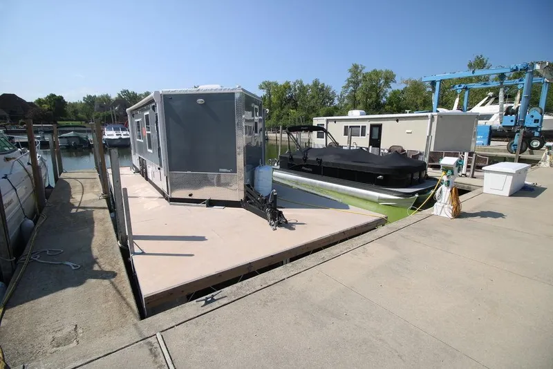 Slide: The Image of Harbor Home 24' 2020 model houseboat docked at a marina on a sunny day. - 14